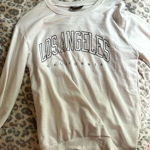 a white gently worn shein los angeles california sweater
